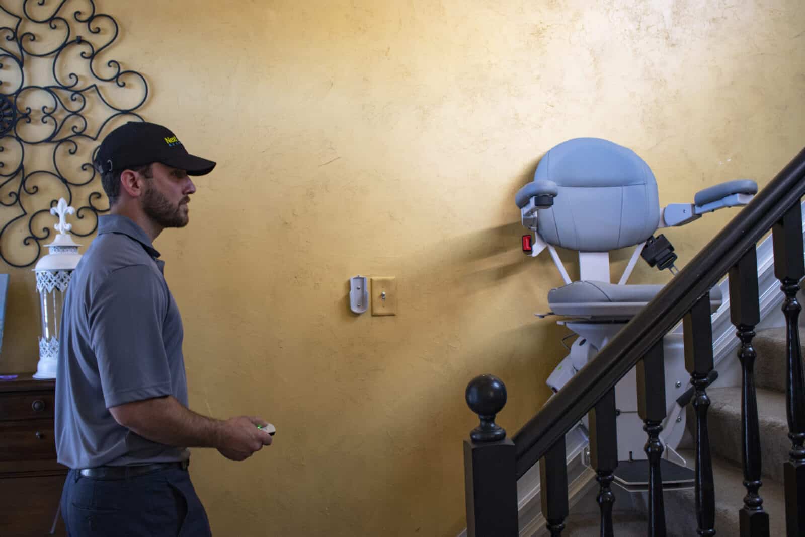 Employee tests remote control of a stair lift that was just installed