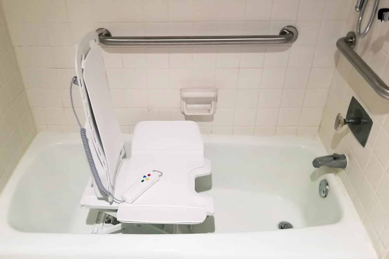 a close up of a shower chair with a remote for the controls