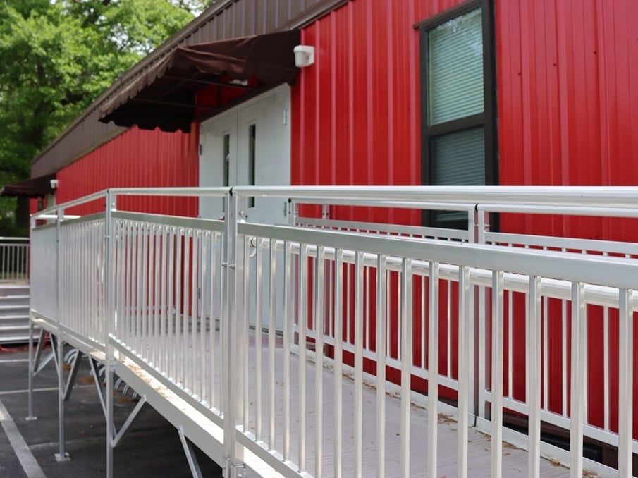 Metal ramp runs along the side of a red painted building