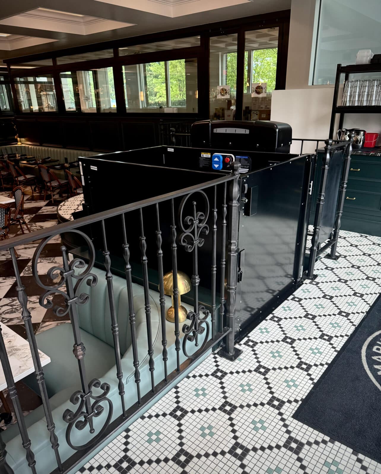 A black commercial vertical platform in a diner.