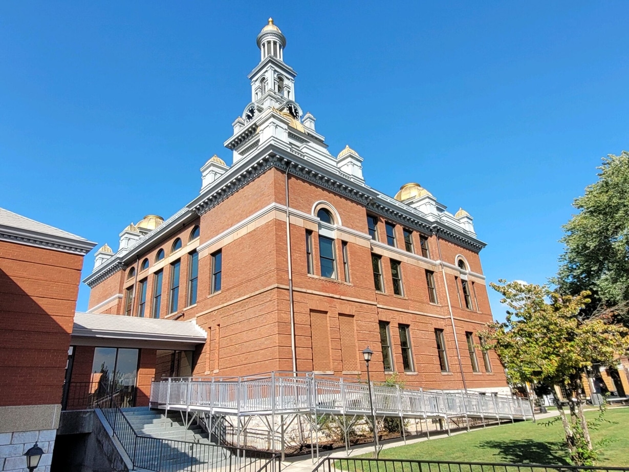 Exterior of a university building with a long ramp installed next to the front steps