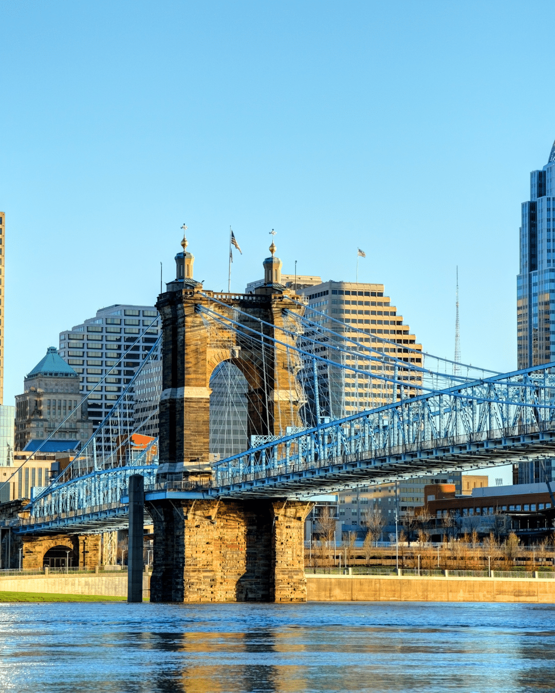 A crew in uniform installing a wheelchair ramp outside of a homeowner's front door