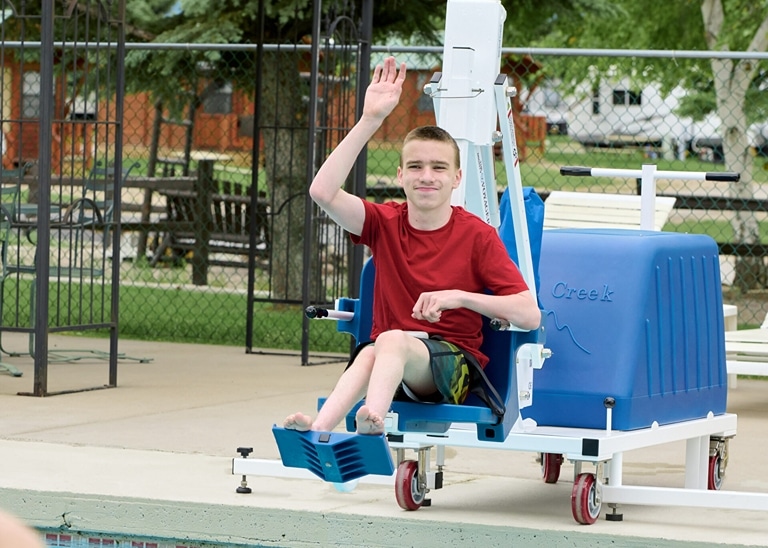 a long winding metal ramp that zig zags up a steep hill next to a cement staircase