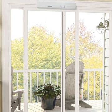 a sliding door to a balcony with an automatic door opener installed above