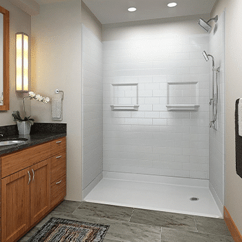 A bathtub that has been converted into a white tiled shower