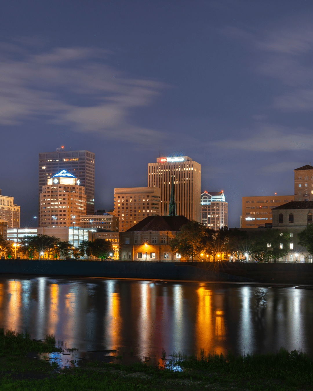 A crew in uniform installing a wheelchair ramp outside of a homeowner's front door