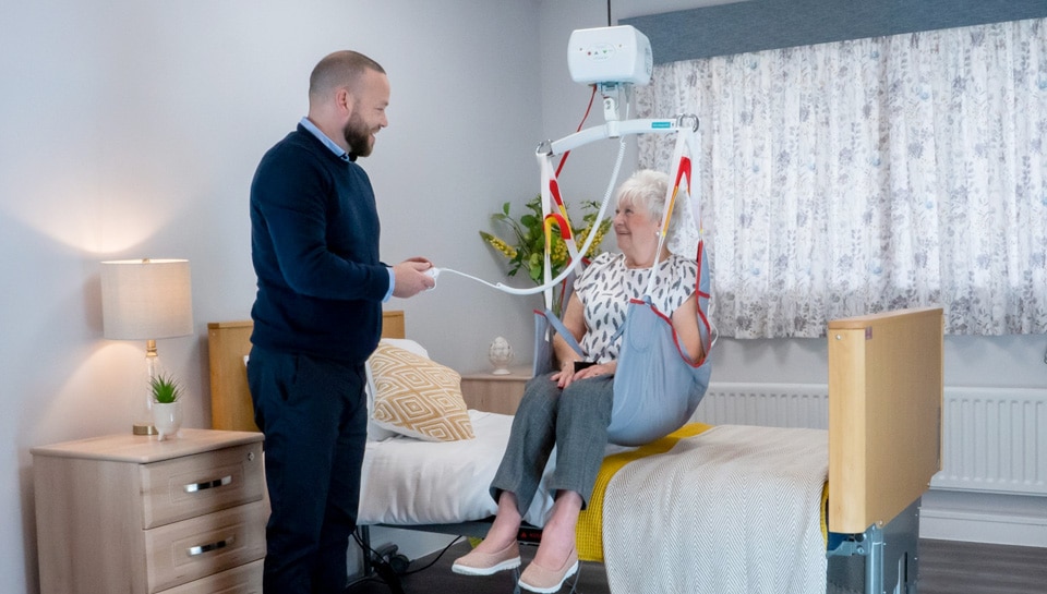 A group of four Next Day Access employees smile at the bottom of a small staircase