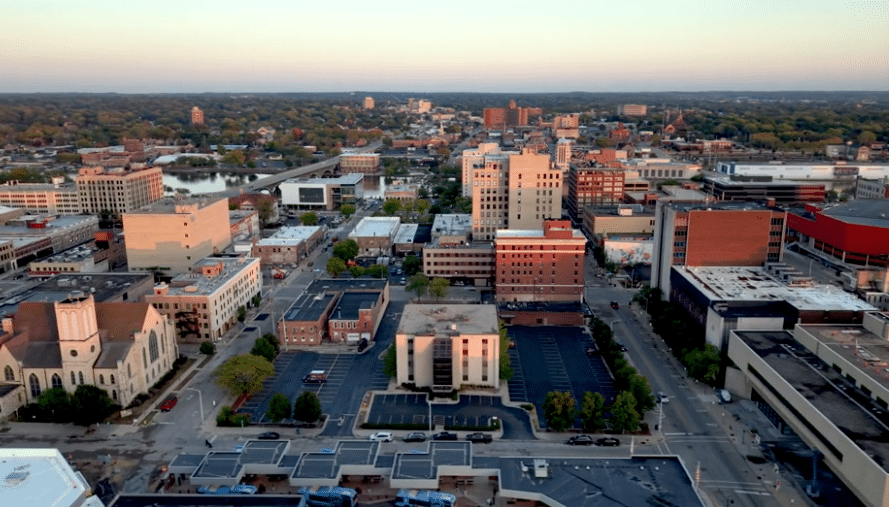 Aerial view of the Chicago skyline and lakefront, featuring the John Hancock Center in the foreground.