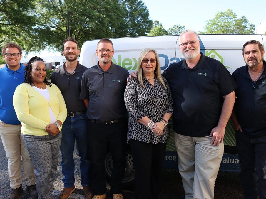 large team photo of next day access employees in uniform