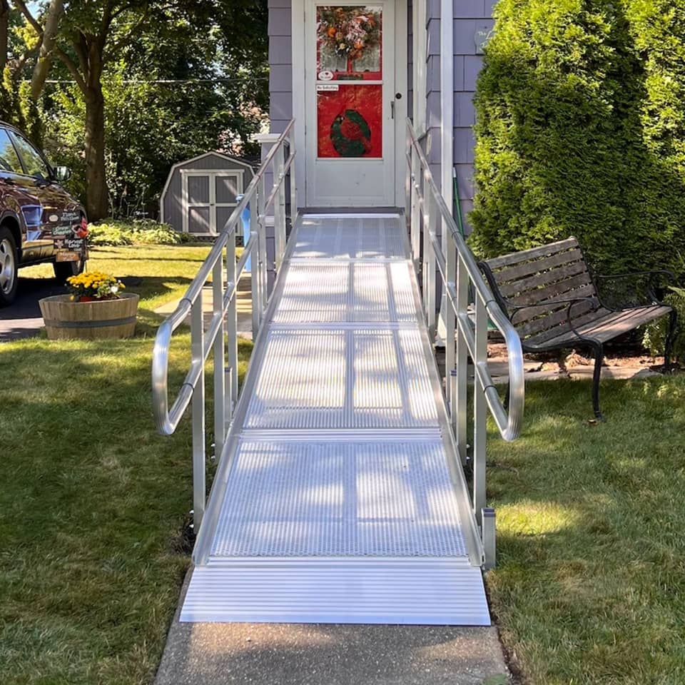 shot looking down a ramp that leads up to the front door of a home