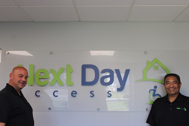 group photo of the long island Next Day Access team in front of a company sign