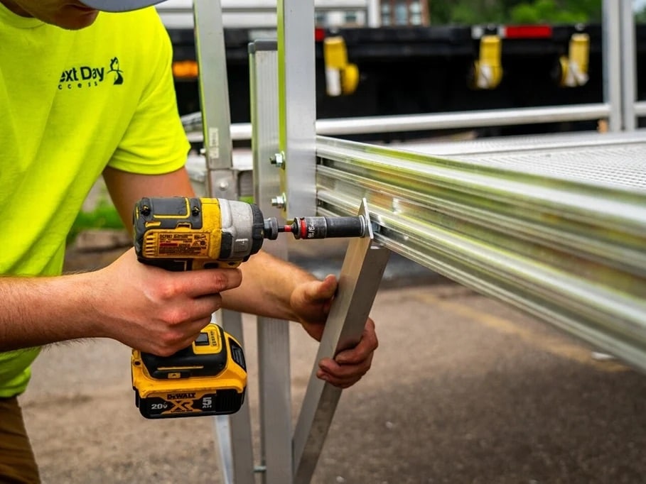 Accessibility expert professionally installing an aluminum wheelchair ramp for Next Day Access Montana.