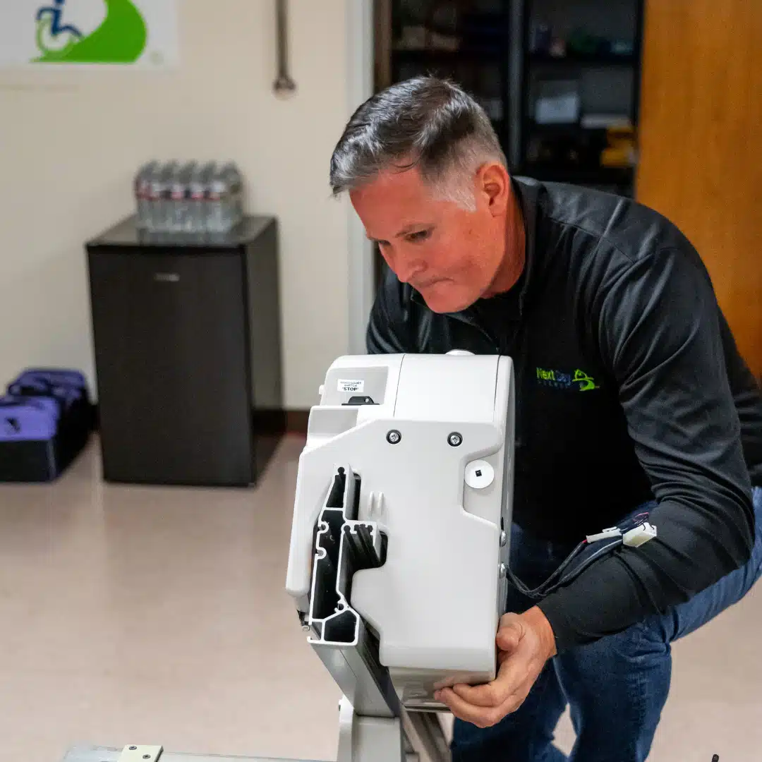 man in uniform realigns a stair lift