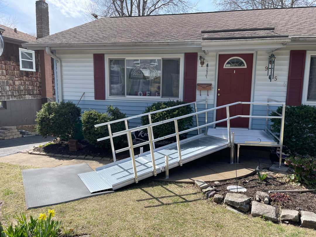 A photo of a wheelchair ramp installed on the front porch of a house