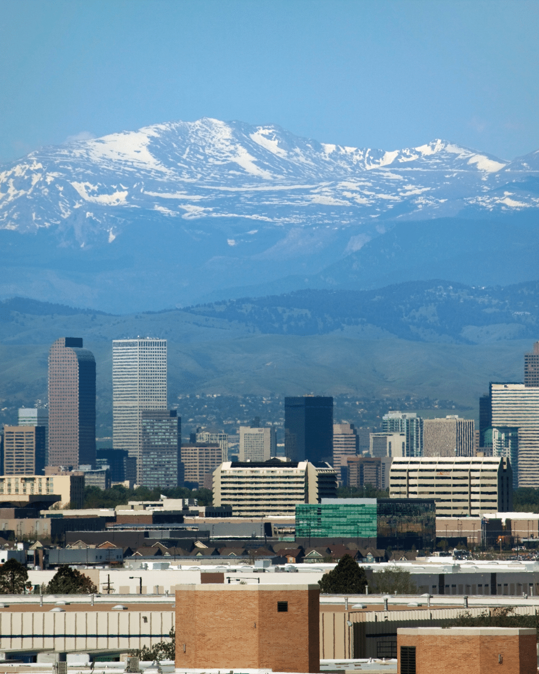 A crew in uniform installing a wheelchair ramp outside of a homeowner's front door