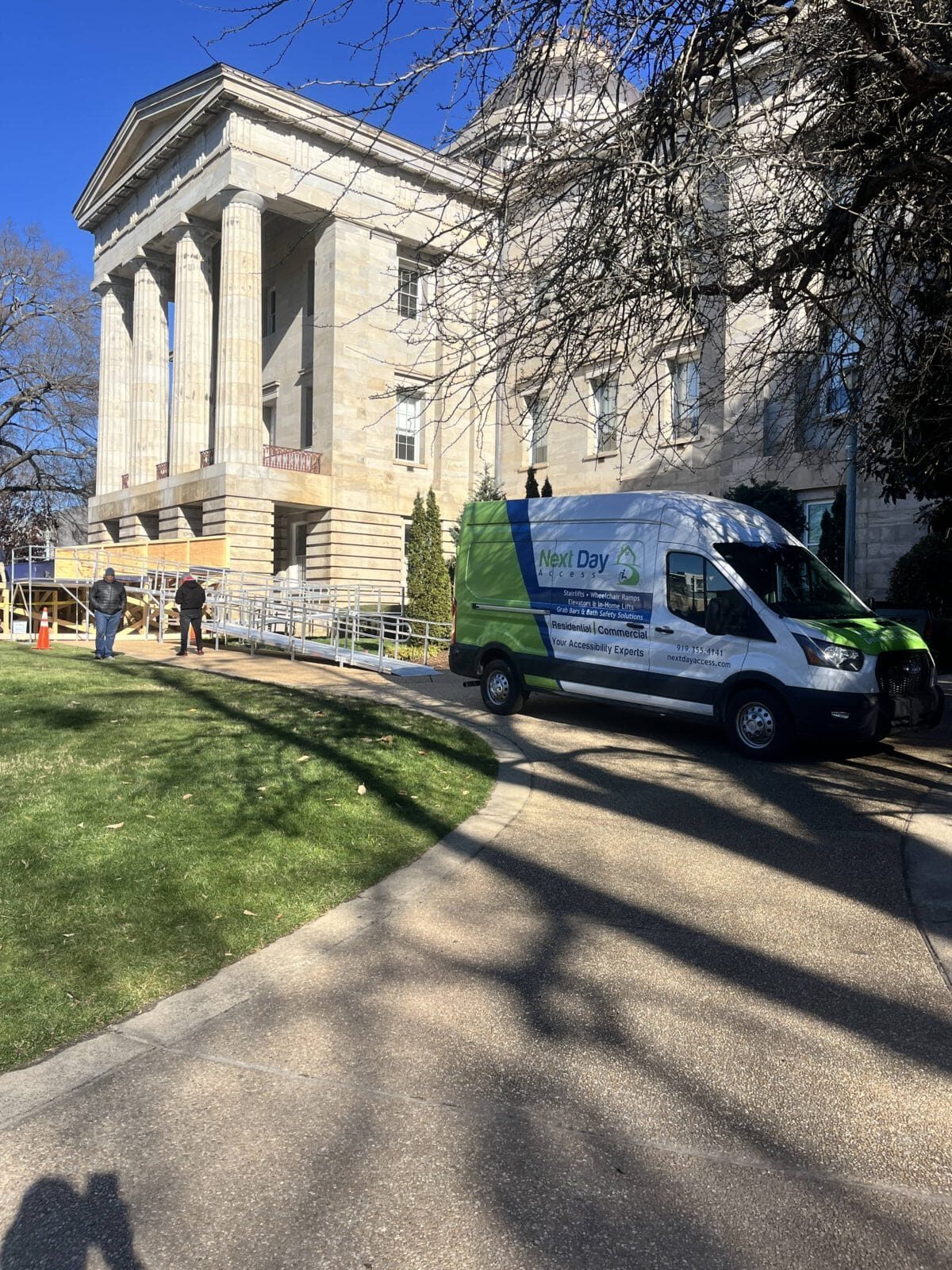 Next Day Access van parked at the NC State Capitol during a commercial wheelchair ramp installation.