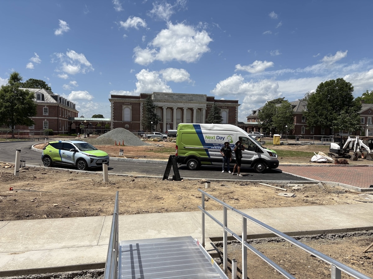 Next Day Access vans parked at Duke University during an aluminum wheelchair ramp installation.