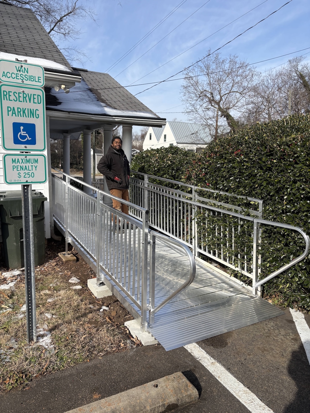 Modular aluminum wheelchair ramp leading to the entrance of a commercial law office in Raleigh.