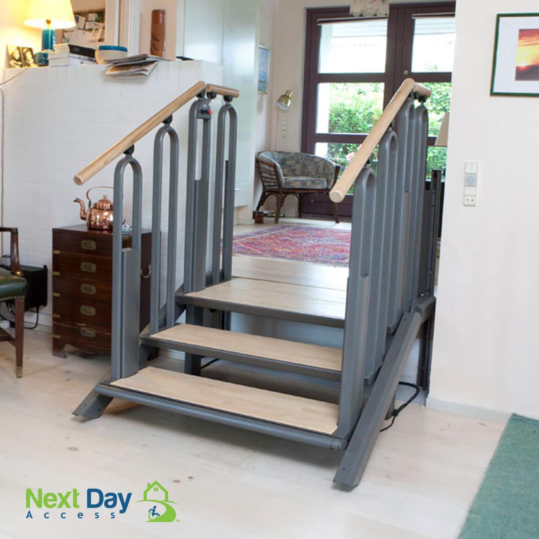 Woman in a wheelchair opens the door to her porch lift and exits onto her raised deck