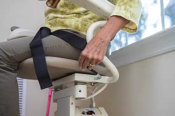 a long winding metal ramp that zig zags up a steep hill next to a cement staircase