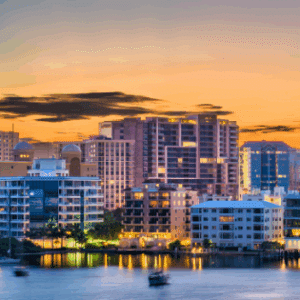 Three men in uniform stand outside next to a pond and discuss build plans
