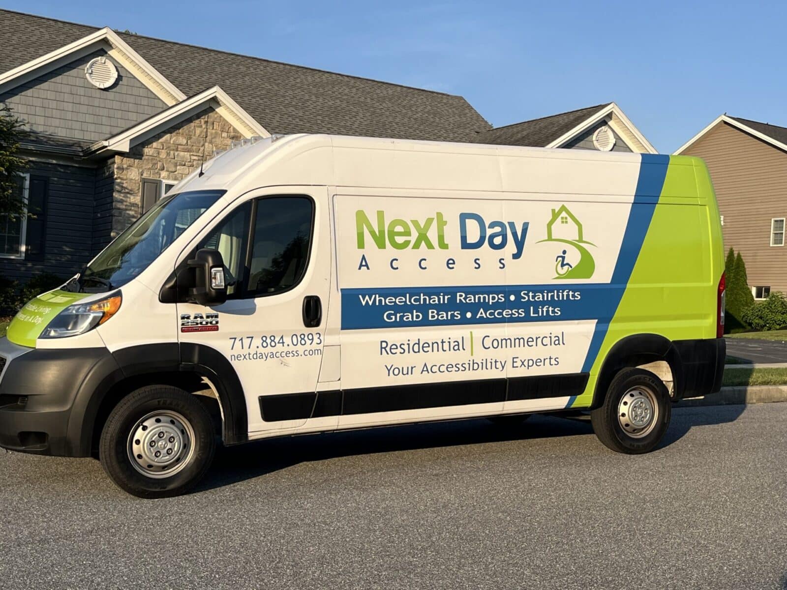 Next Day Access service van displaying branding, services (Wheelchair Ramps, Stairlifts, Grab Bars, Access Lifts), and contact information.