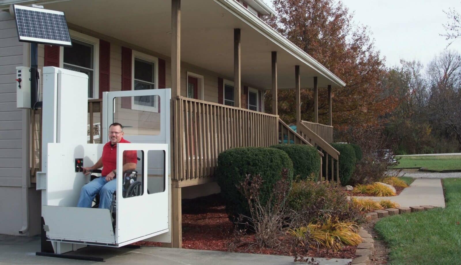 a long winding metal ramp that zig zags up a steep hill next to a cement staircase