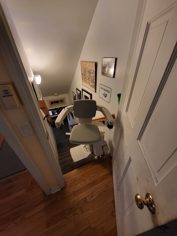 Stairlift installed on basement stairs helping a homeowner access hobby space
