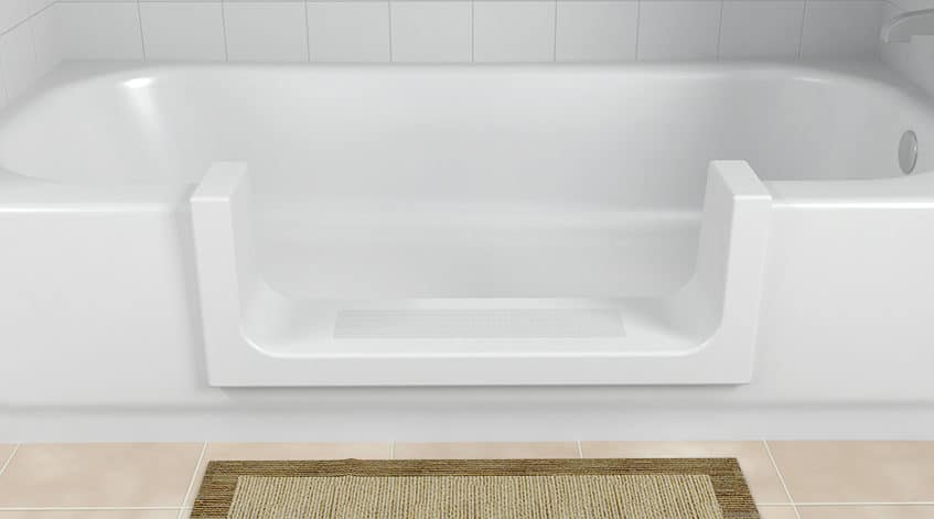 White bathtub retrofit with a low-cut step-through insert and a textured anti-slip floor strip.