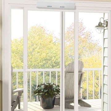 a sliding door to a balcony with an automatic door opener installed above