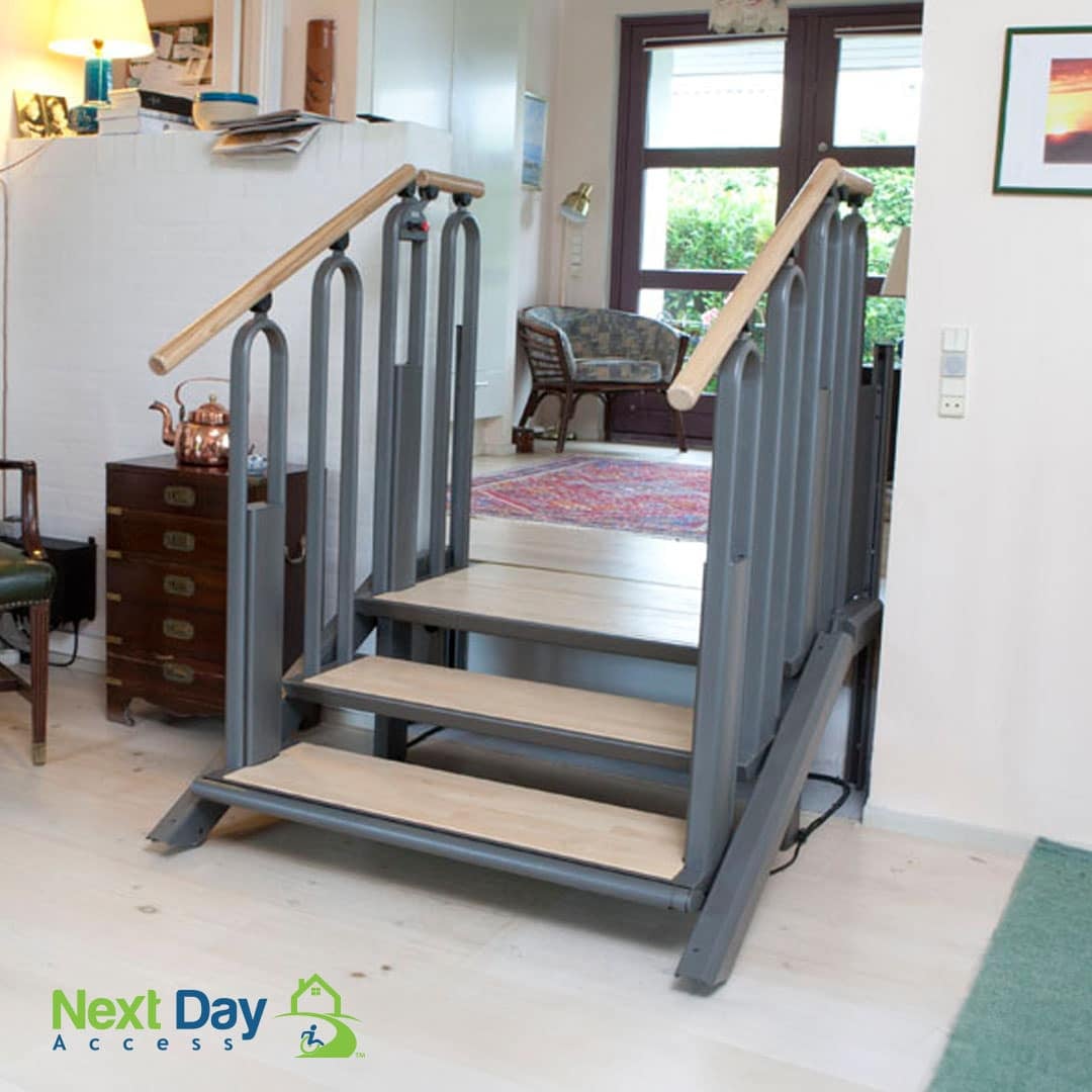 Woman in a wheelchair opens the door to her porch lift and exits onto her raised deck