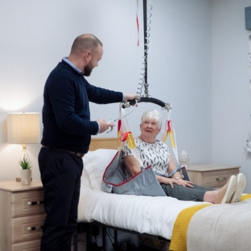Patient in the hospital sitting in bed on a lift