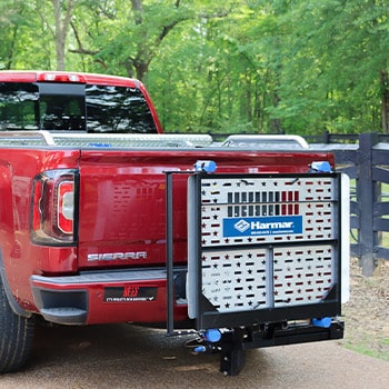 A wheelchair/scooter lift installed on the back of a red pickup truck