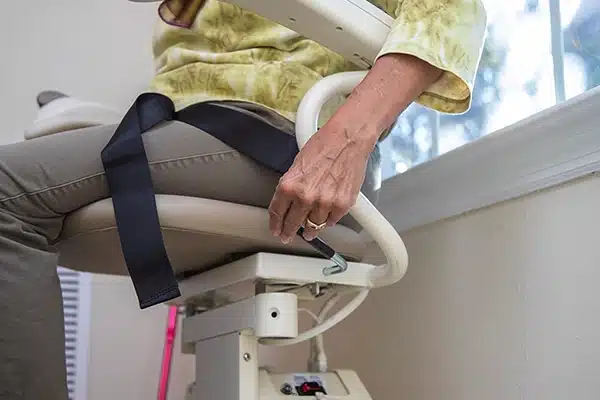 a long winding metal ramp that zig zags up a steep hill next to a cement staircase
