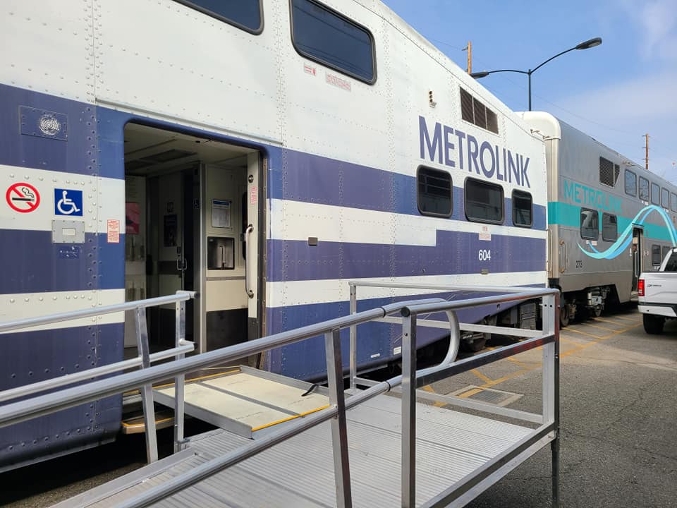 A ramp leads up to a train car parked on the tracks
