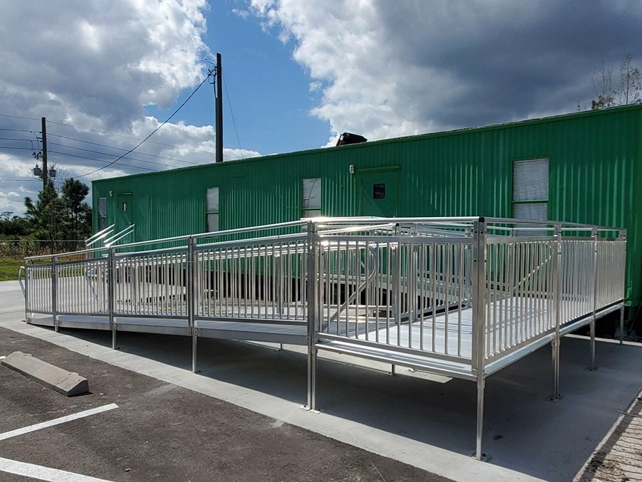 Green mobile office with a ramp installed in front of the door
