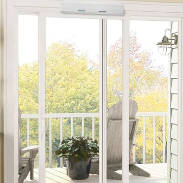 a sliding door to a balcony with an automatic door opener installed above