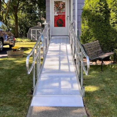 shot looking down a ramp that leads up to the front door of a home