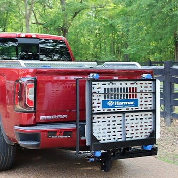 A wheelchair/scooter lift installed on the back of a red pickup truck