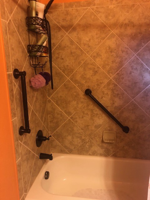 Black Finish Grab Bars in Warm Toned Bathroom