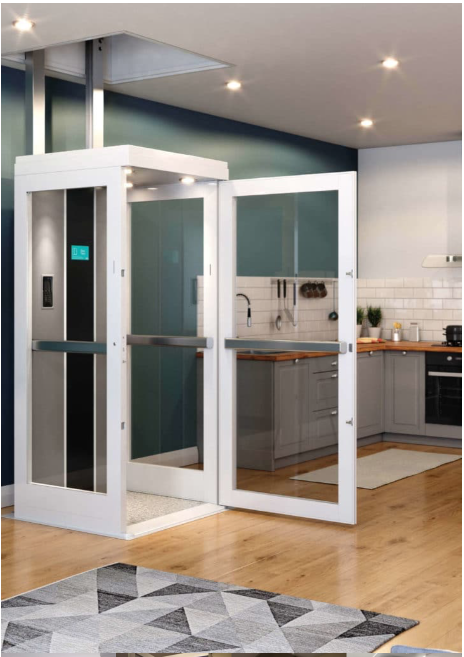 Product shot of a white and glass paneled elevator in a green walled kitchen with wood floors.