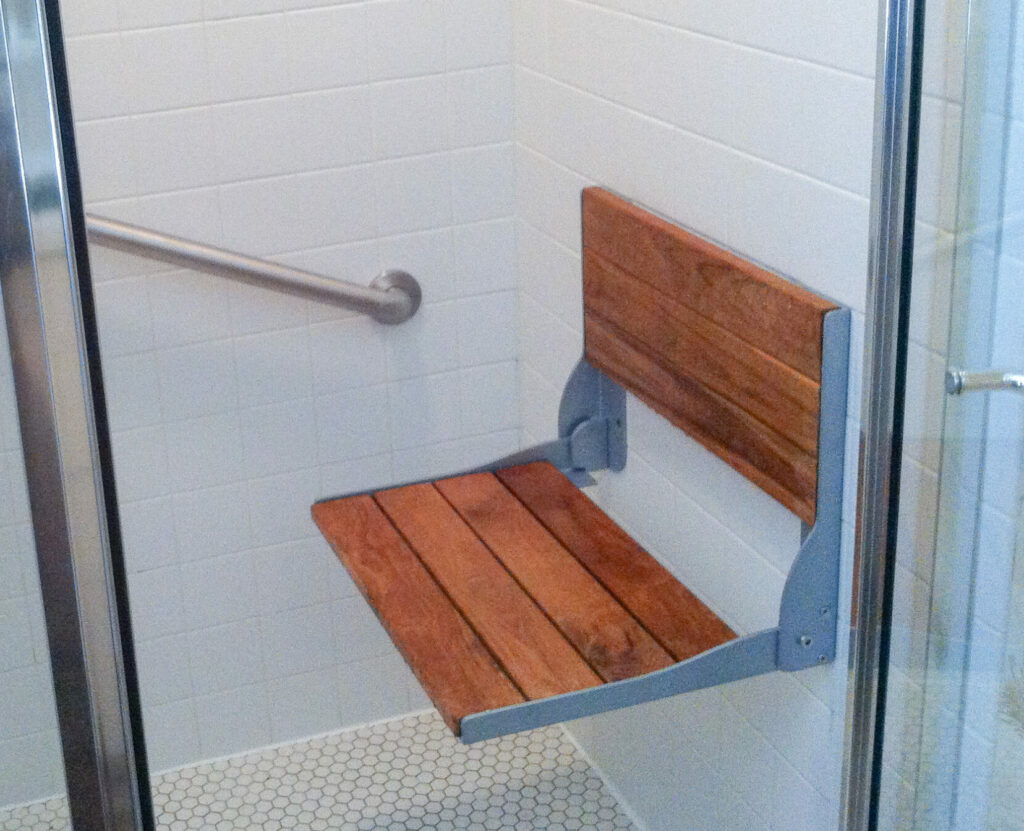 Vetical and Horizontal GrabBars in White Bathroom With Wood Seat 2