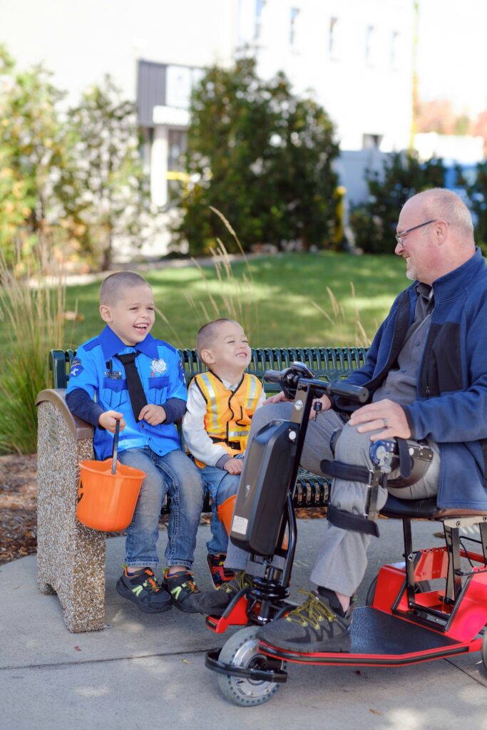 Inclusive design in a park allows man to ride scooter along path